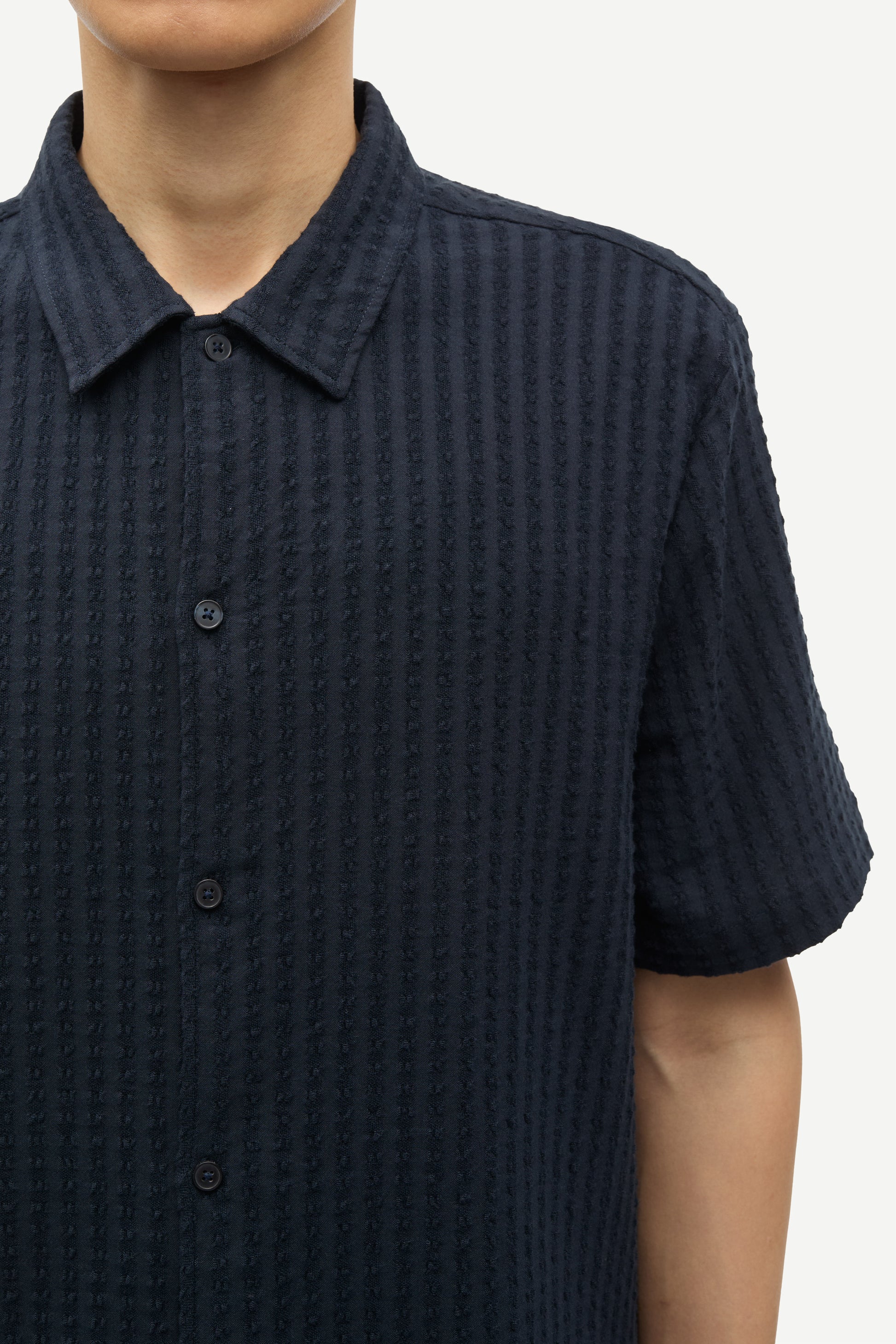 Close up of navy cotton stretch shirt