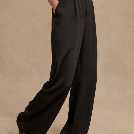 wide leg black viscose trousers with pleated front and side pockets side view