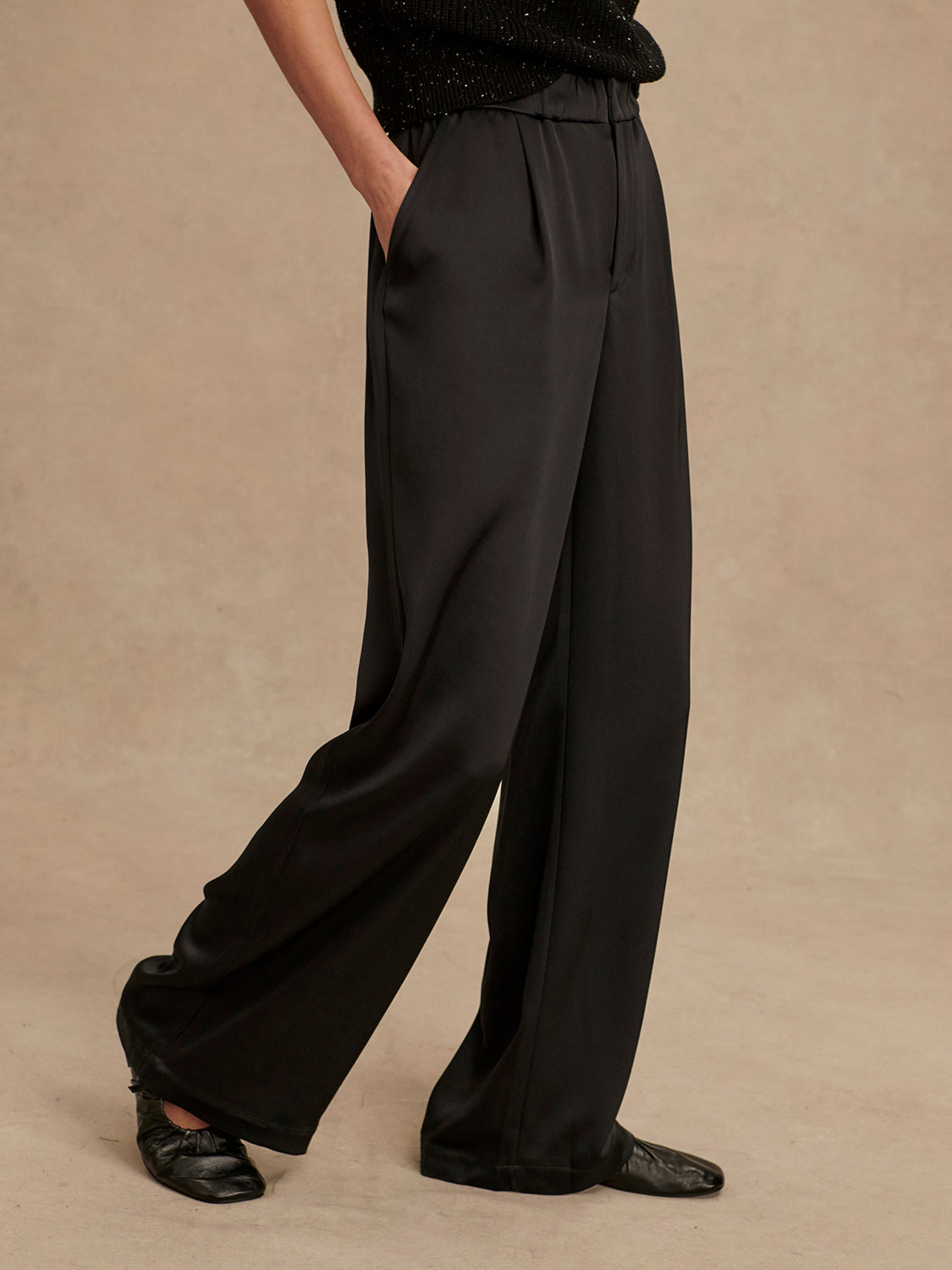 wide leg black viscose trousers with pleated front and side pockets side view