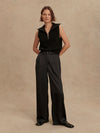wide leg black viscose trousers with pleated front and side pockets model shot