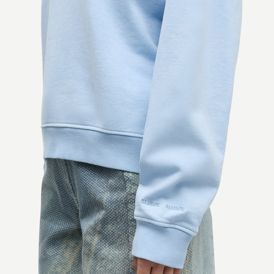 light blue round neck cotton jumper with rib detailing close up