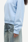 light blue round neck cotton jumper with rib detailing close up