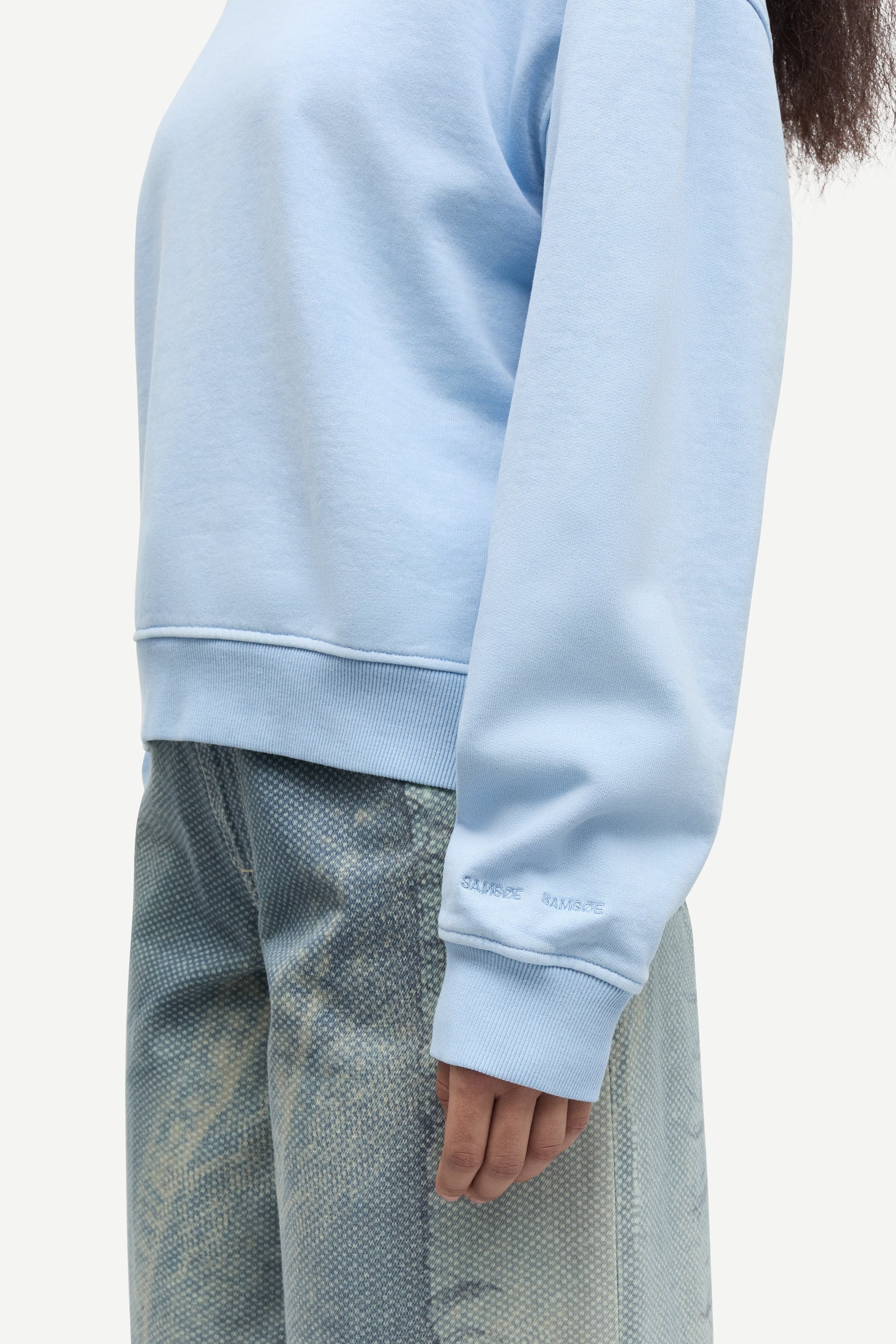 light blue round neck cotton jumper with rib detailing close up