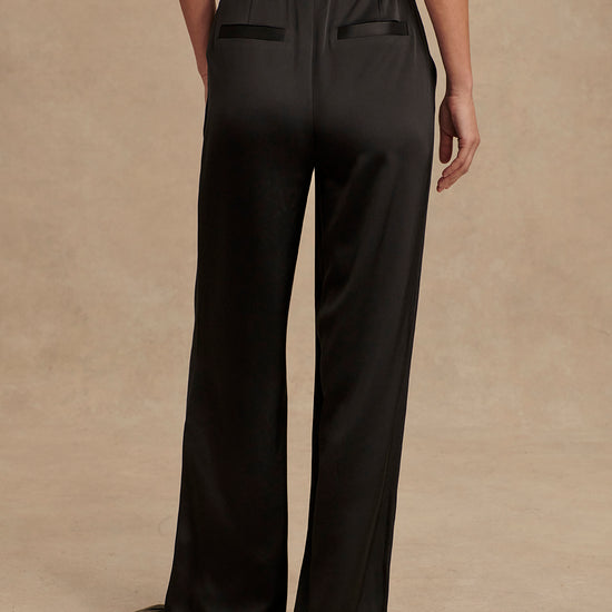 wide leg black viscose trousers with pleated front and side pockets rear view