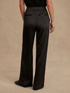 wide leg black viscose trousers with pleated front and side pockets rear view