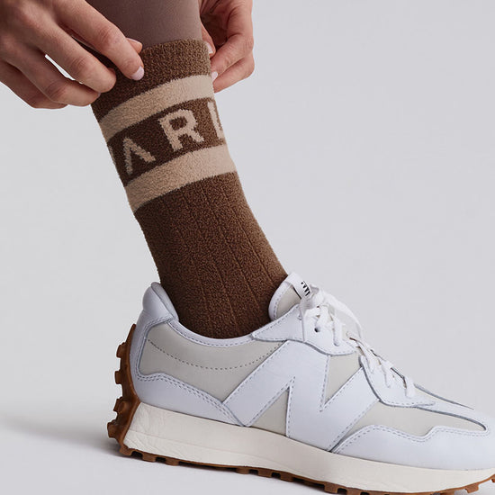 brown and bronze coloured varley logo sock model shot