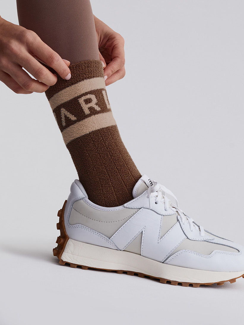 brown and bronze coloured varley logo sock model shot