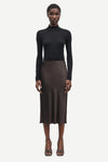 Short mid length satin slip skirt in chocolate brown from samsoe samsoe model shot