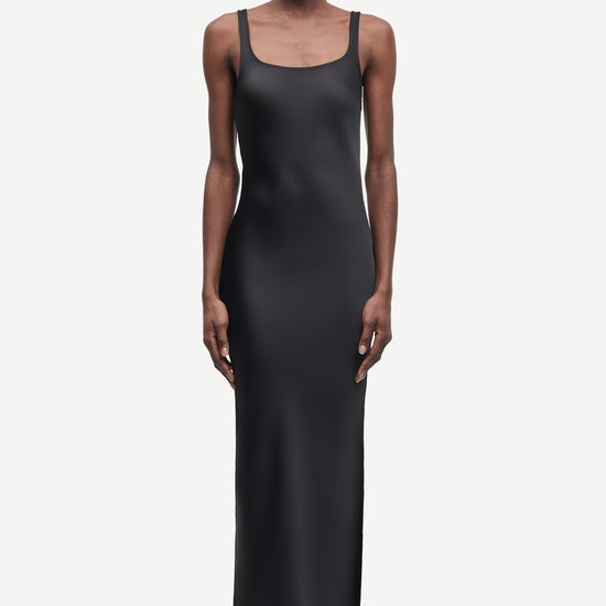 black slip dress with wide straps and figure hugging fit from samsoe samsoe model shot