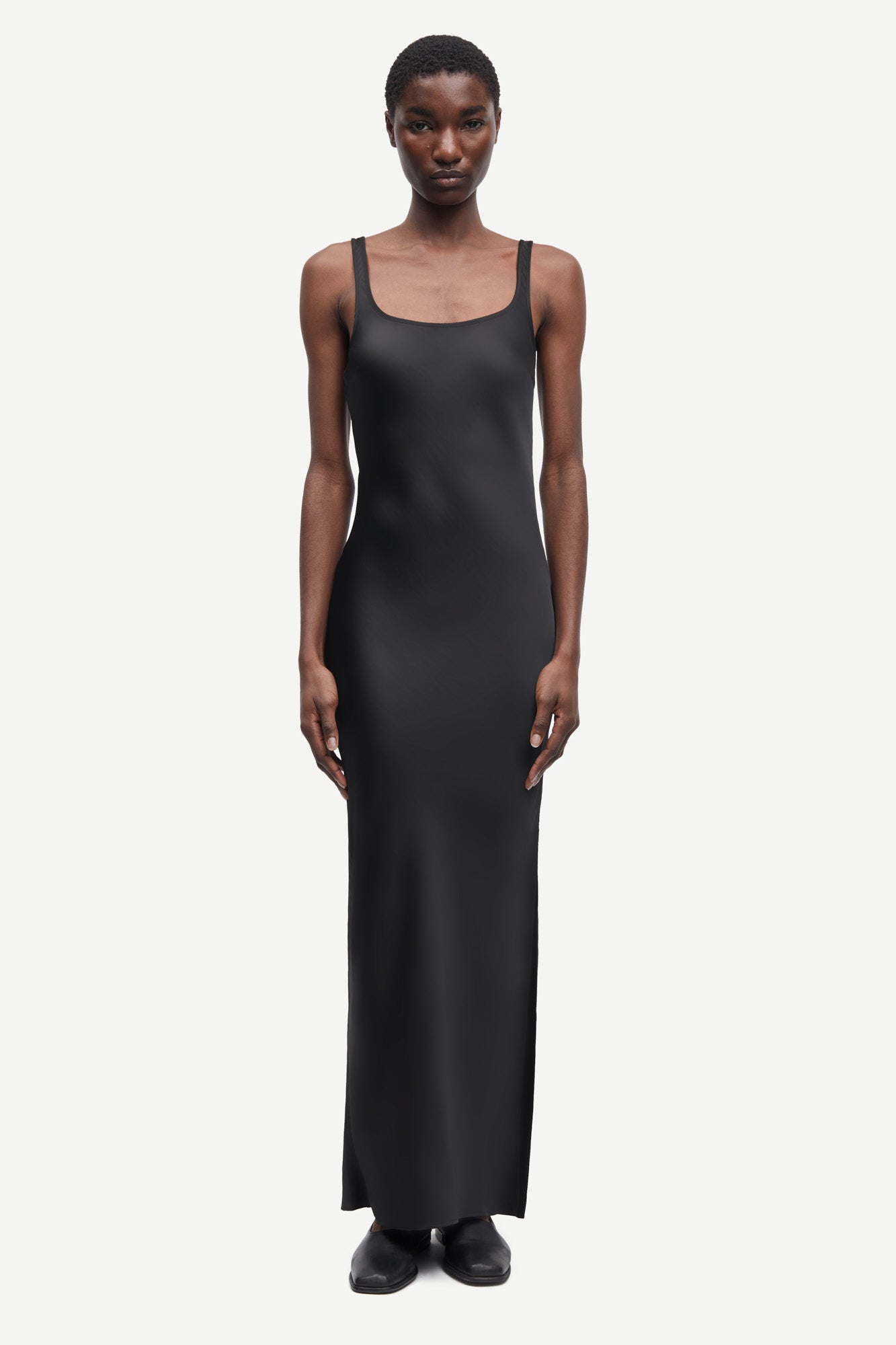 black slip dress with wide straps and figure hugging fit from samsoe samsoe model shot
