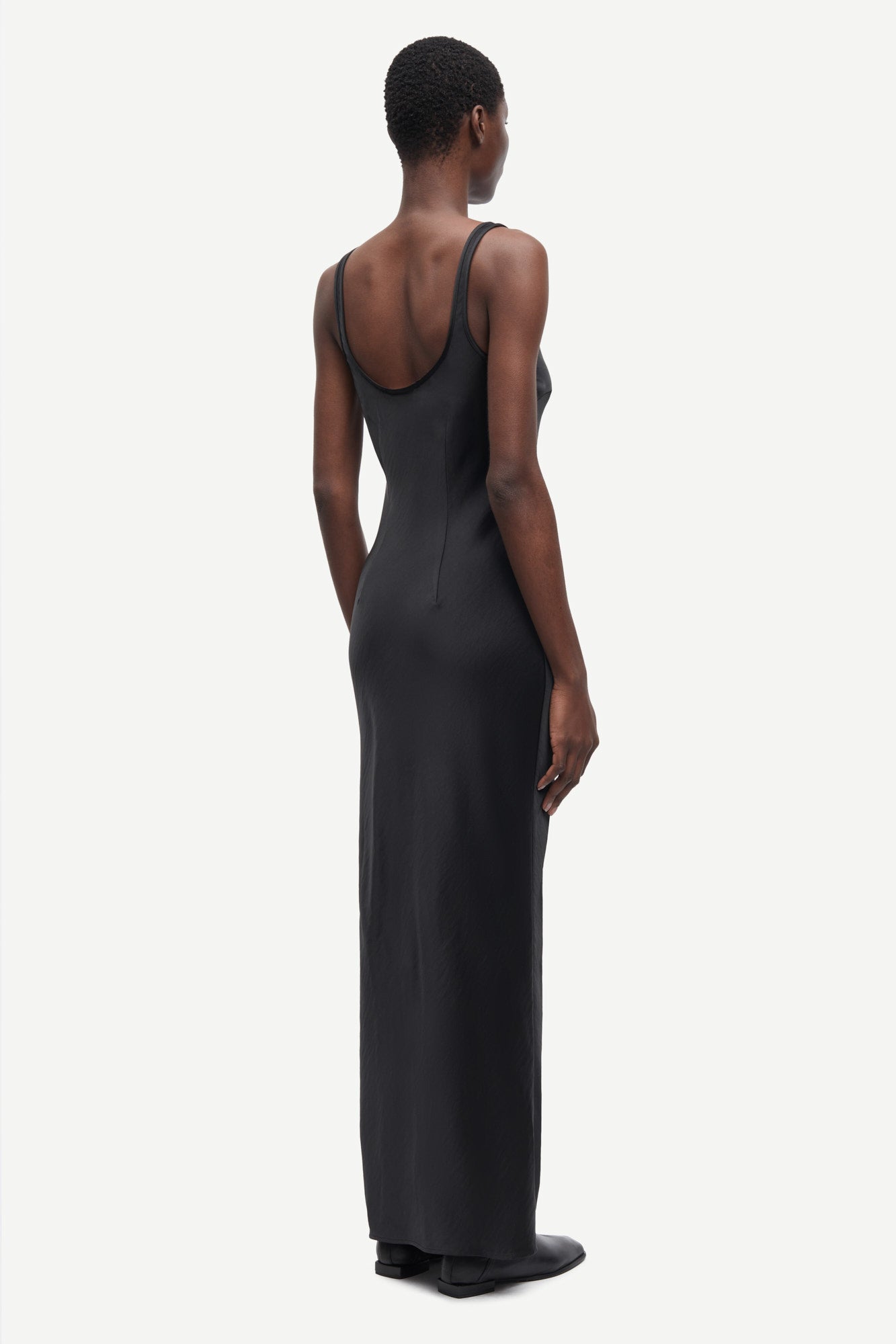 black slip dress with wide straps and figure hugging fit from samsoe samsoe rear view