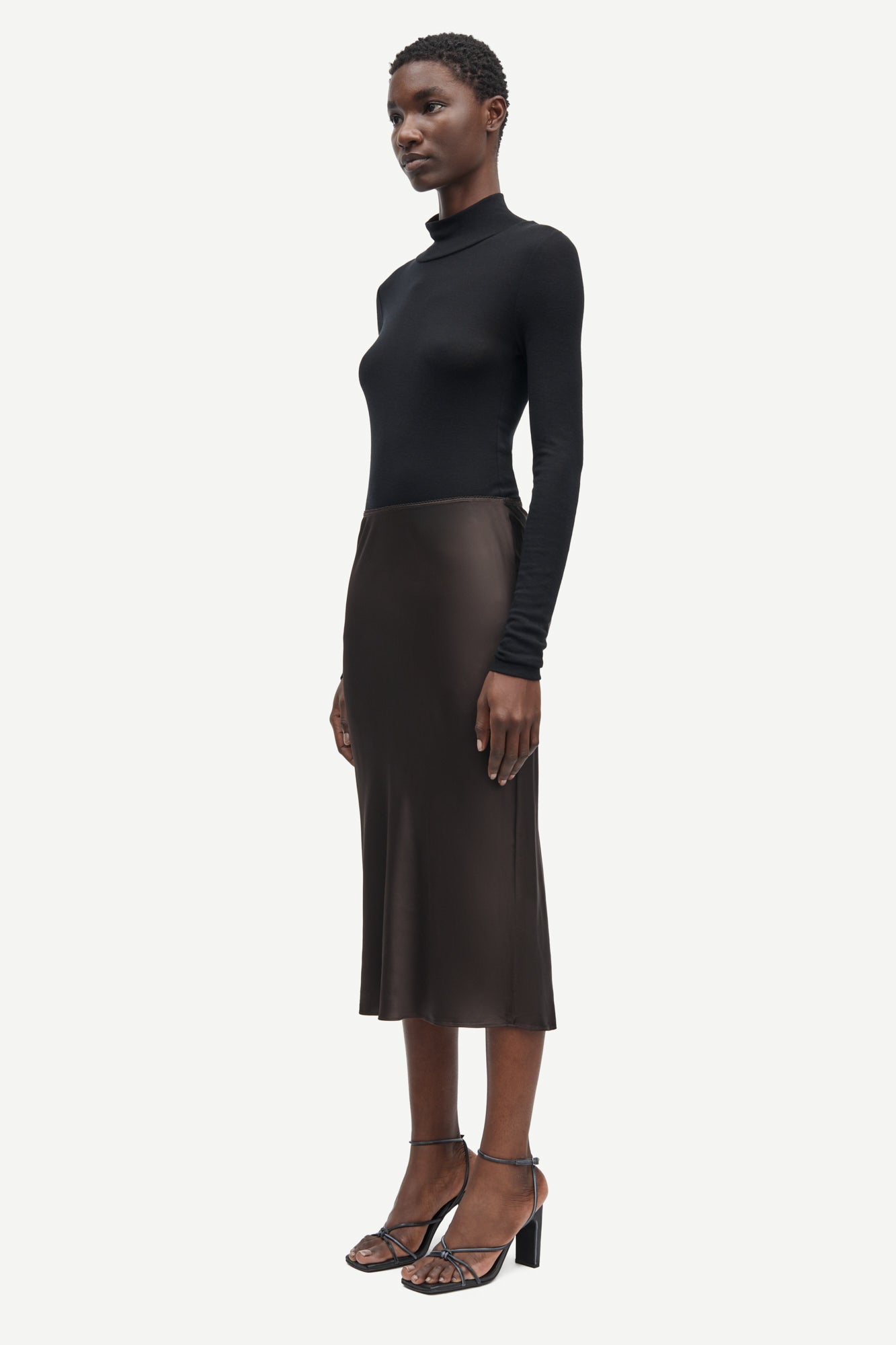 Short mid length satin slip skirt in chocolate brown from samsoe samsoe side view