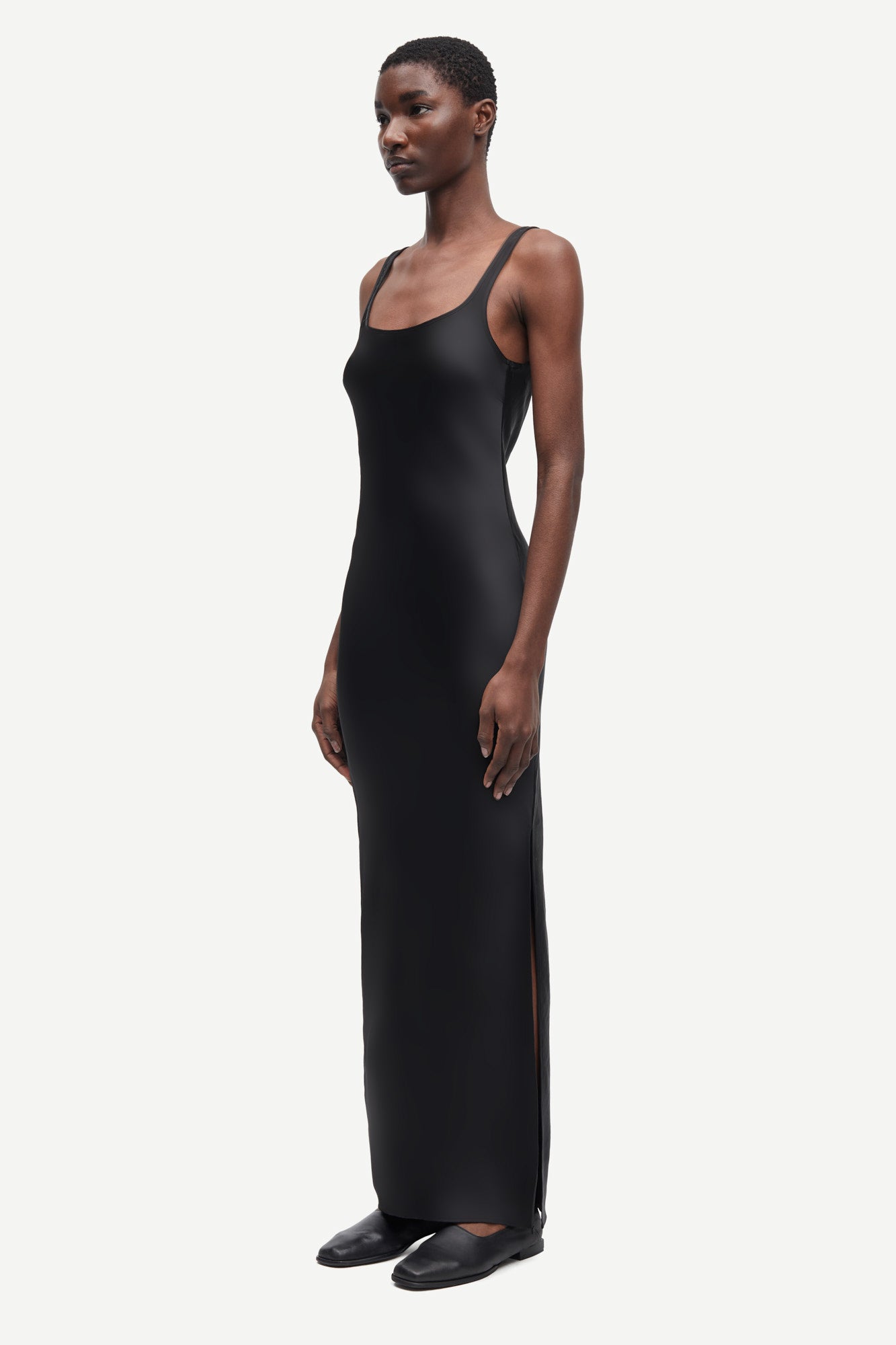 black slip dress with wide straps and figure hugging fit from samsoe samsoe side view