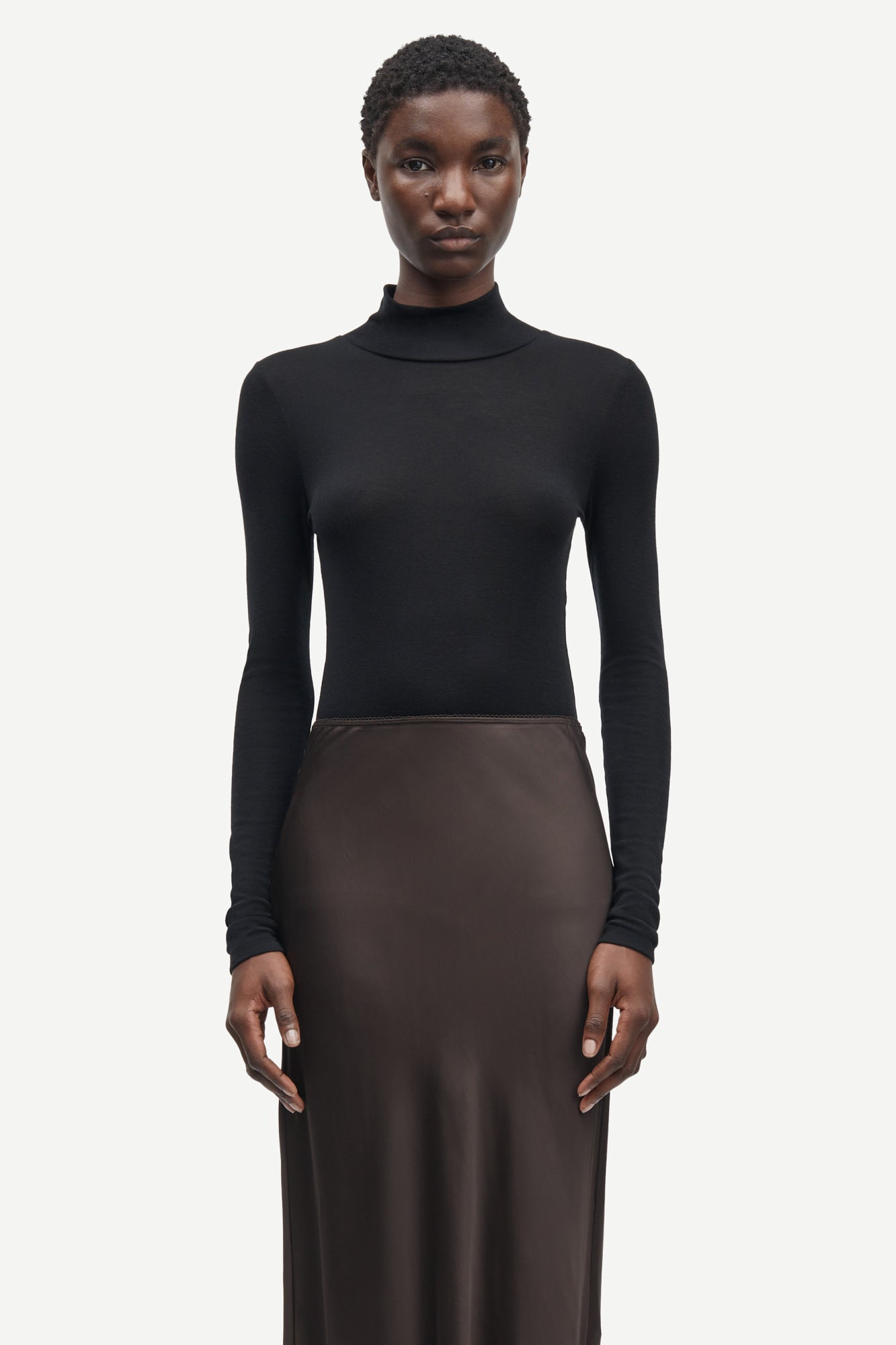 Short mid length satin slip skirt in chocolate brown from samsoe samsoe close up model shot