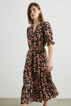 Model shot of floral print dress with short sleeves and tiered skirt