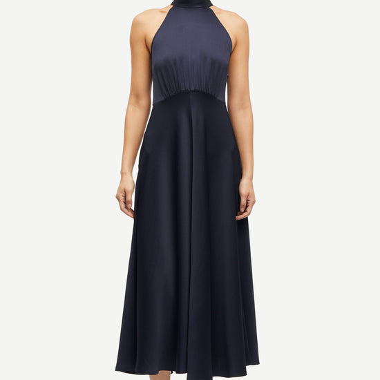 navy blue halterneck dress with open back and tie detail from samsoe samsoe model shot