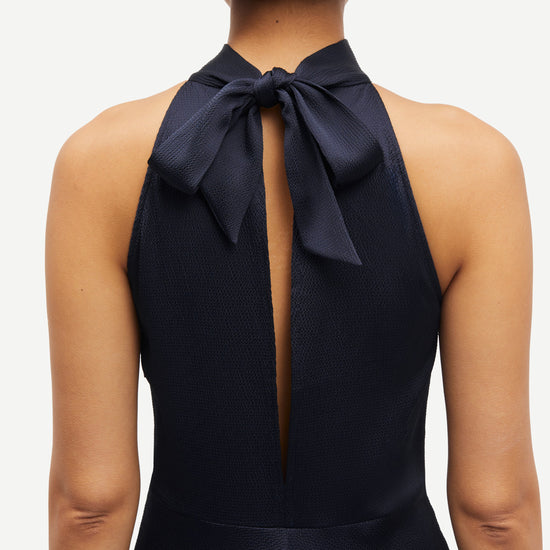 navy blue halterneck dress with open back and tie detail from samsoe samsoe rear view close up