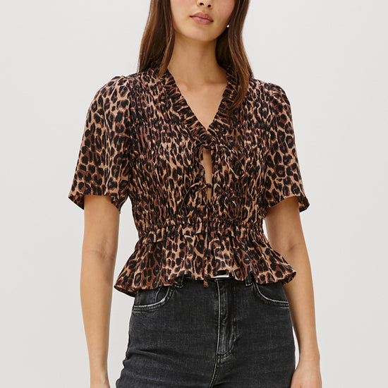 animal print v neck short sleeve top with tie detailing and ruffled neck model shot