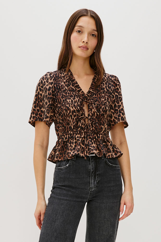 animal print v neck short sleeve top with tie detailing and ruffled neck model shot