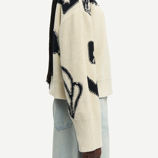 round neck cream cotton jumper with black floral print and ribbed hem, cuffs and neck from samsoe side view