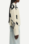round neck cream cotton jumper with black floral print and ribbed hem, cuffs and neck from samsoe side view