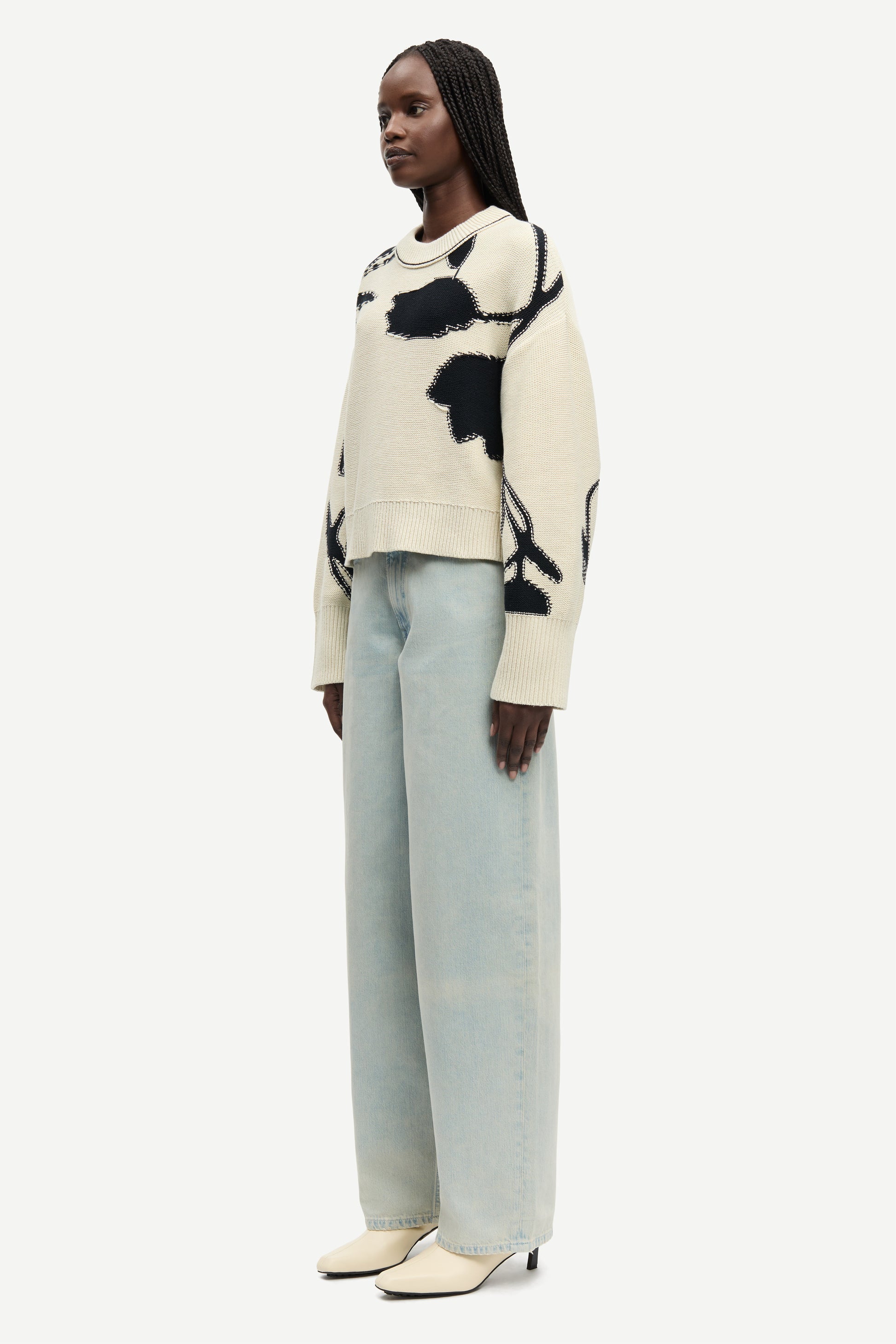round neck cream cotton jumper with black floral print and ribbed hem, cuffs and neck from samsoe side view
