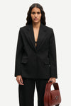 notch lapel black blazer with flap pockets and single button from samsoe model shot