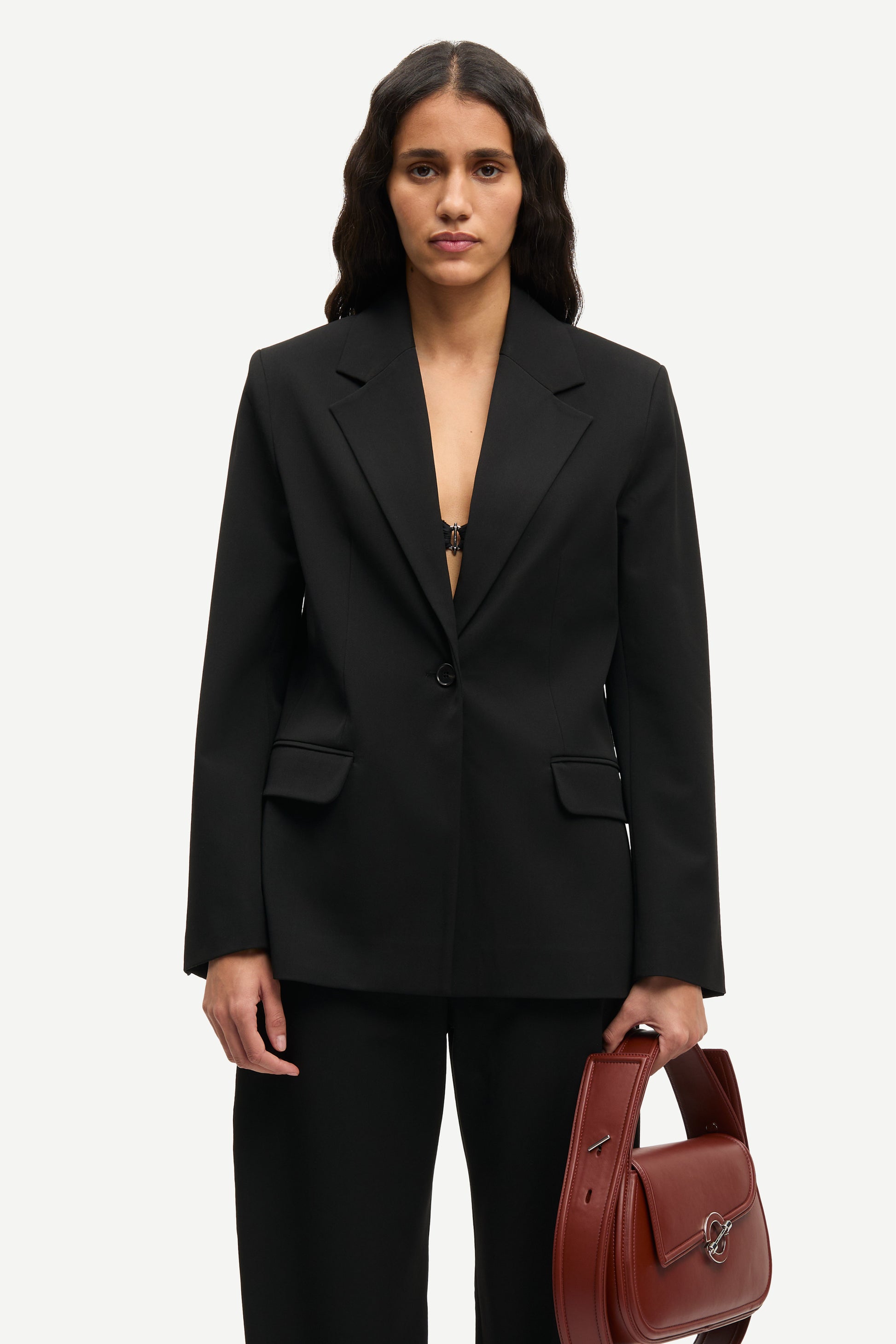 notch lapel black blazer with flap pockets and single button from samsoe model shot