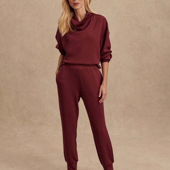 Slim fit maroon coloured sweat pants with ankle cuff and elasticated waistband model shot