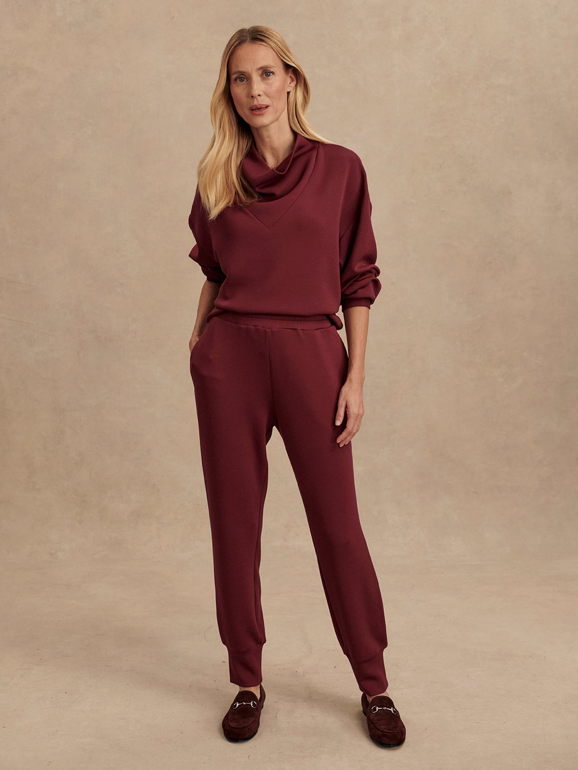 Slim fit maroon coloured sweat pants with ankle cuff and elasticated waistband model shot