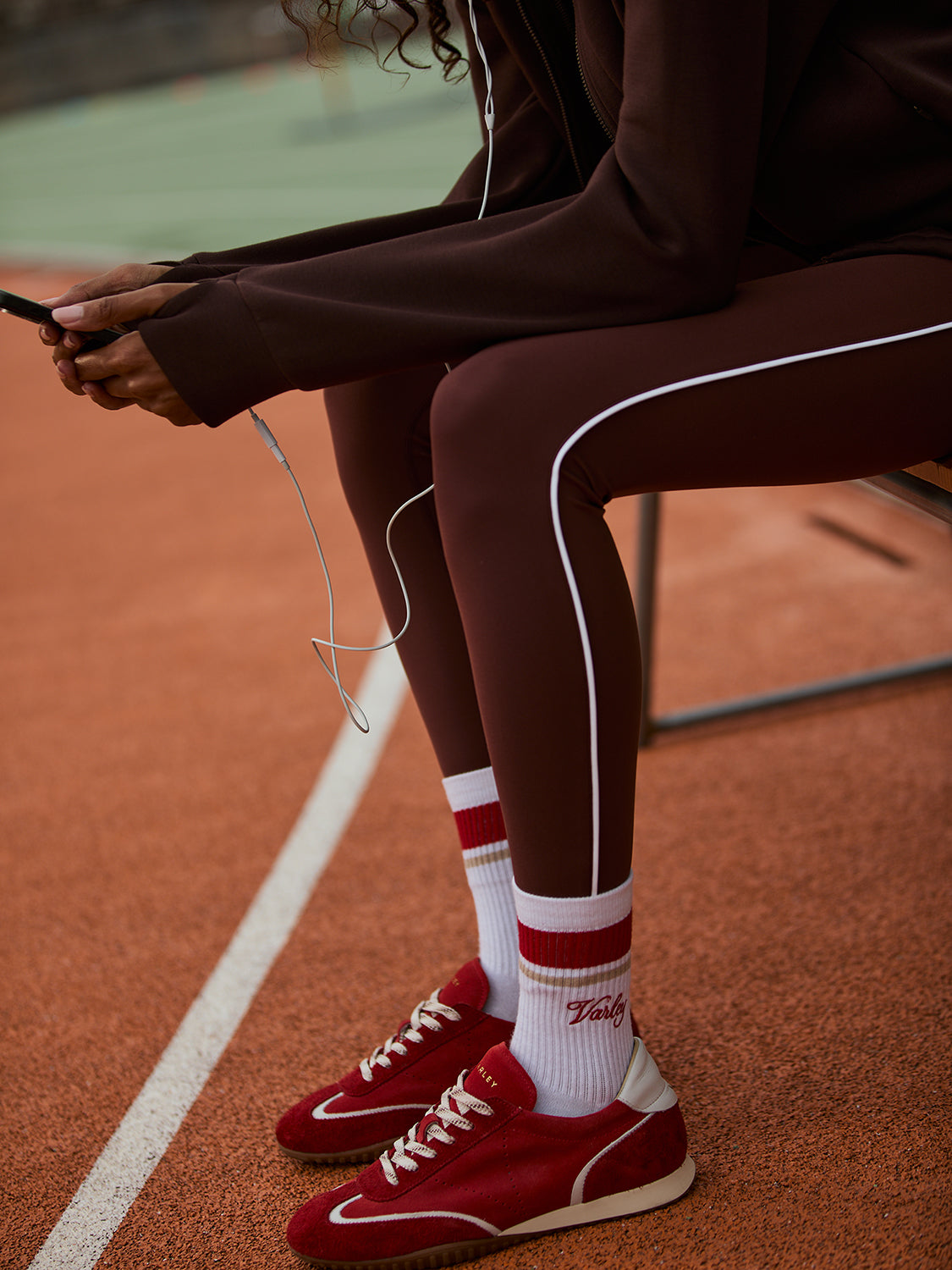 high rise brown leggings with white piping on the side from varley model shot