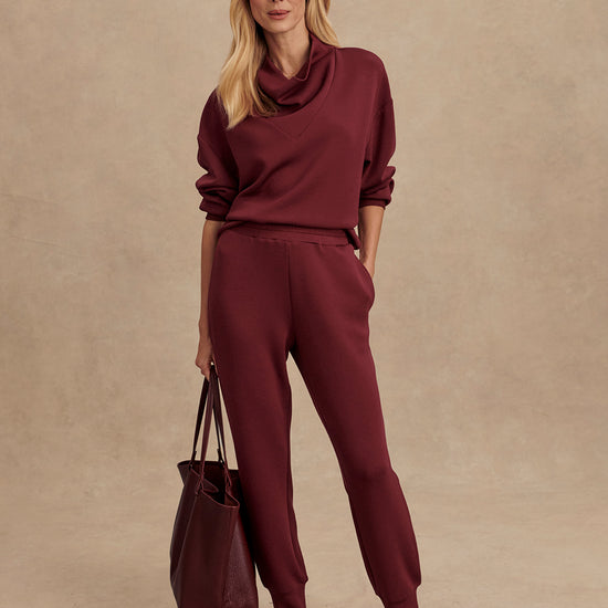 Slim fit maroon coloured sweat pants with ankle cuff and elasticated waistband model shot