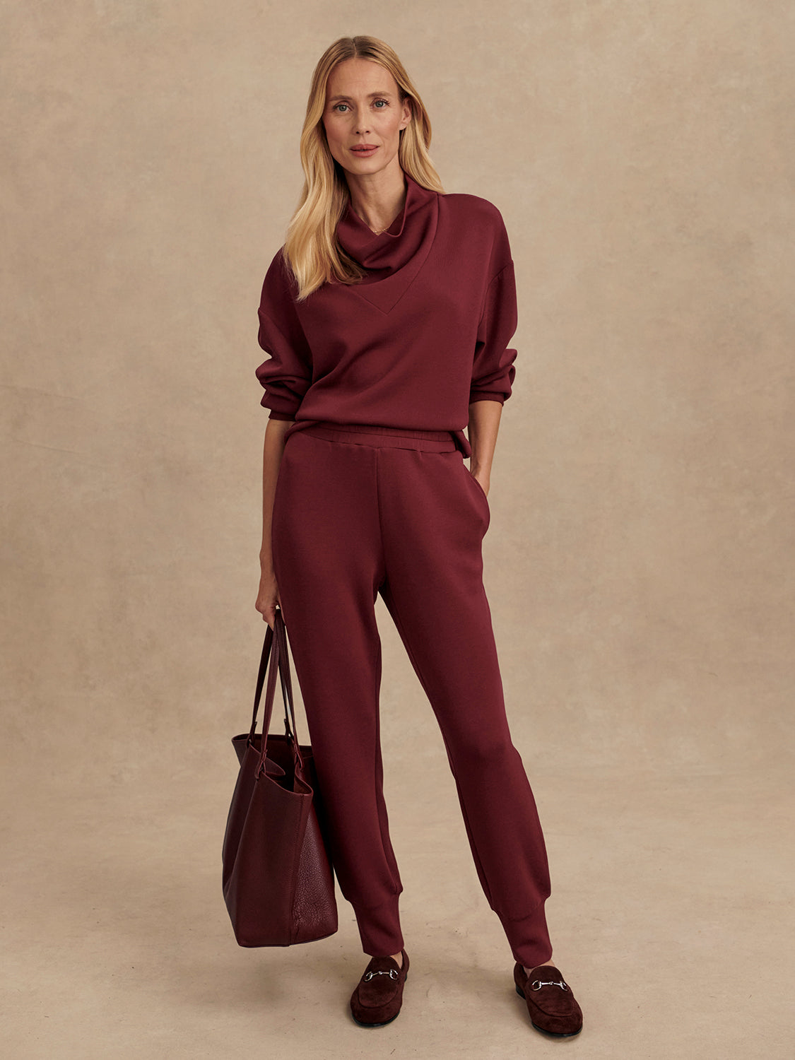 Slim fit maroon coloured sweat pants with ankle cuff and elasticated waistband model shot