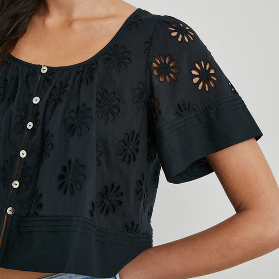 Daisy style broderie anglais top in black with short sleeves and a scoop neck close up of sleeve