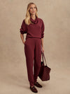 Slim fit maroon coloured sweat pants with ankle cuff and elasticated waistband model shot