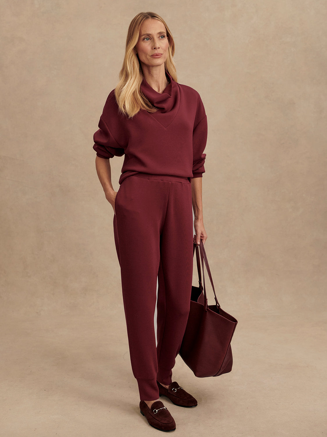 Slim fit maroon coloured sweat pants with ankle cuff and elasticated waistband model shot