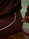 high rise brown leggings with white piping on the side from varley close up