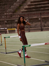 high rise brown leggings with white piping on the side from varley model shot