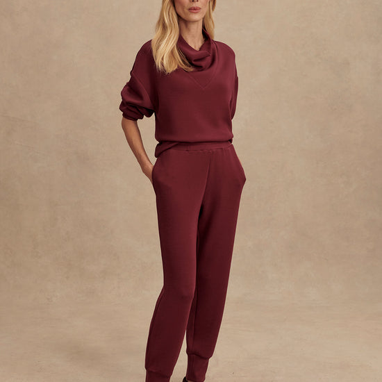 Slim fit maroon coloured sweat pants with ankle cuff and elasticated waistband model shot