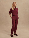 Slim fit maroon coloured sweat pants with ankle cuff and elasticated waistband model shot