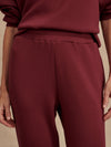 Slim fit maroon coloured sweat pants with ankle cuff and elasticated waistband close up