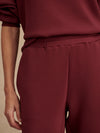 Slim fit maroon coloured sweat pants with ankle cuff and elasticated waistband close up