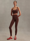 high rise brown leggings with white piping on the side from varley model shot