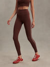 high rise brown leggings with white piping on the side from varley model shot