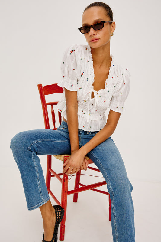 V neck short sleeve ruffle sleeve white top with tie at front and embroidered flowers from rails model