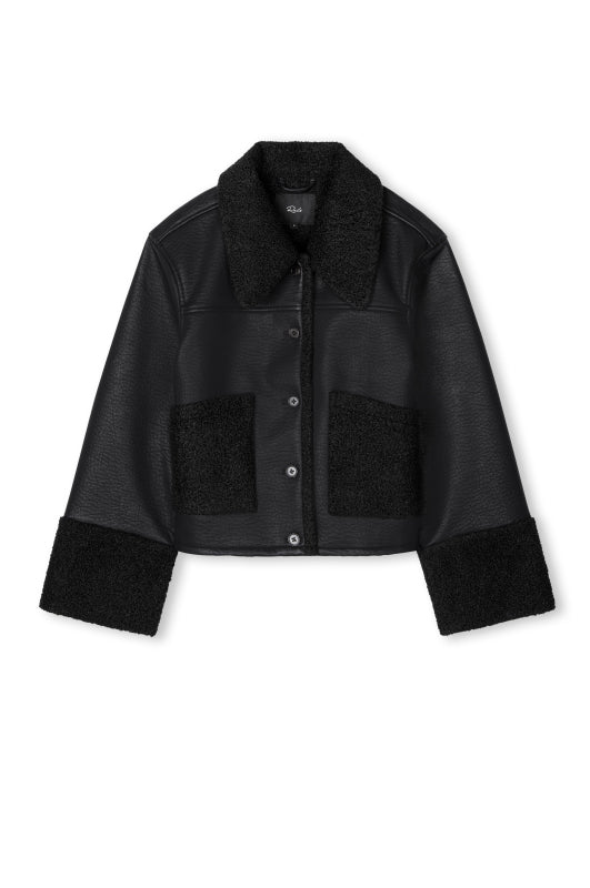 black shearling jacket with leather exterior, shearling pockets, collar and cuffs in a boxy fit 