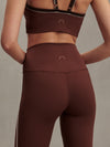 high rise brown leggings with white piping on the side from varley close up