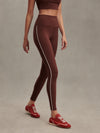 high rise brown leggings with white piping on the side from varley