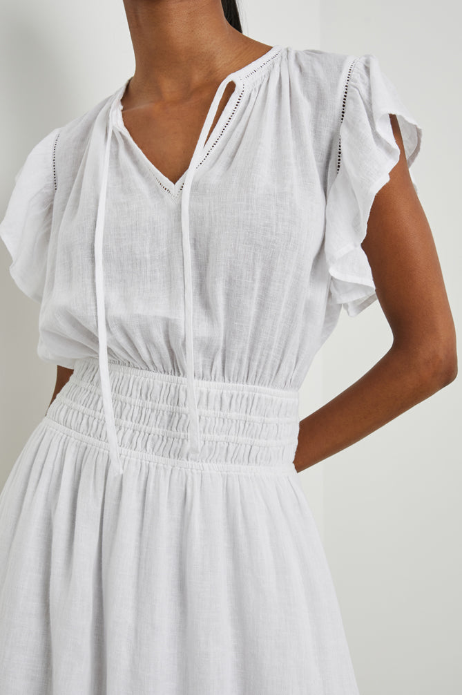 white midi dress with lace inserts and ruched waistline