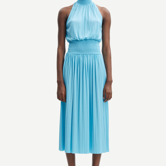 Light blue halterneck top with ruched waist and light pleats throughout midi in length